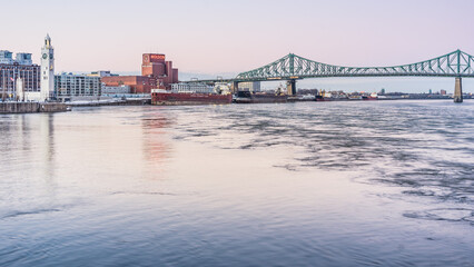 View at sunset on the clock tower, the Molson factory and Jacques Cartier Bridge in Montreal,...