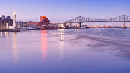 Fototapeta premium View at sunset on the clock tower, the Molson factory and Jacques Cartier Bridge in Montreal, Quebec (Canada)