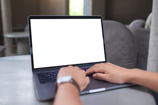 Mockup image of a woman working and typing on laptop with blank white desktop screen