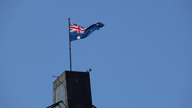 Australia flag on the rooftop with a blue sky