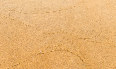 Wave pattern on sand beach, blank brown sand texture background
