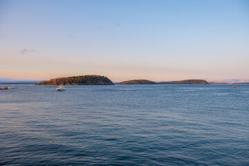 Frenchman Bay with Bar Island and Sheep Porcupine Island at the background at sunset in historic town center of Bar Harbor, Maine ME, USA. 