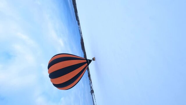FV Vertical 4k Aerial View of Hot Air Balloon Parachute and Basket in Snow in Cold Winter Landscape, Drone Shot 50fps