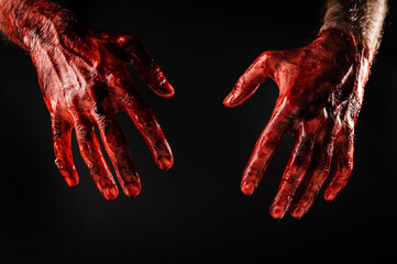 Male bloody hands on a black background.  - obrazy, fototapety, plakaty
