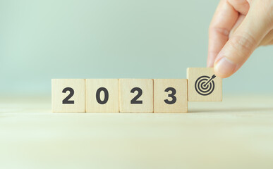 2023 goals of business or life. Wooden cubes with 2023 and goal icon on smart background. Starting...