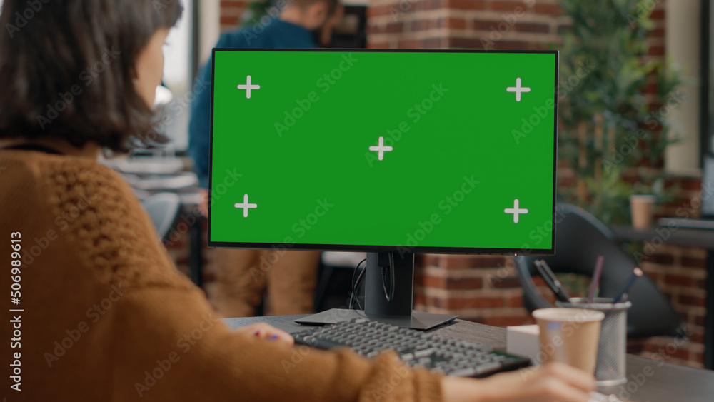 Poster close up of employee using computer with green screen at desk. business woman using monitor with iso