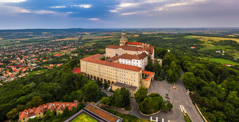 Pannonhalma, Hungary - Aerial panoramic view of the beautiful Millenary Benedictine Abbey of Pannonhalma (Pannonhalmi Apatsag) with blue sky and green foliage at summertime
