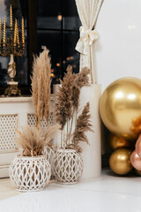 Photo area for the holiday. Festive photo area in the restaurant is decorated with inflatable layers, gold, pink, peach with dryness near the windows