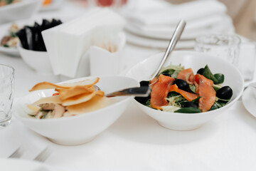 Appetizer. Cold table. dish of red fish on the table with salads and greens