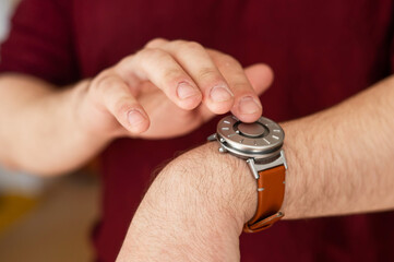 Special wristwatch for the blind with magnetic balls.  - obrazy, fototapety, plakaty