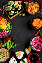 Assortment of Korean food on dark background.