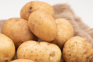 Fototapeta na wymiar Fresh yellow potato on white background