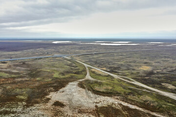 asphalt road and bridge over a lake in the steppe photo from a quadcopter landscape