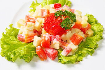 Fruit salad is a healthy snack consisting of pieces of fruit, pineapple, watermelon, papaya, strawberries, which are doused with a creamy and delicious sauce.