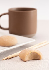 Coffee Flavored Mochi Ice Cream on a Table with a Cup of Coffee