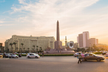 CAIRO, EGYPT - DECEMBER 29, 2021: The Obelisk of Ramses II is surrounded by four ancient sandstone sphinxes in Cairo, Egypt