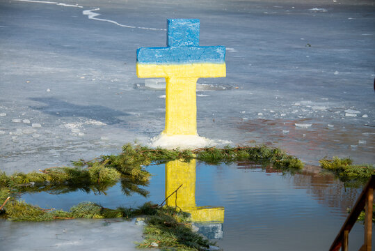 The ice cross over the ice-hole is painted in the colors of the Ukrainian flag. Baptism of the Lord. Ukraine. Belogorodka. January 18, 2022