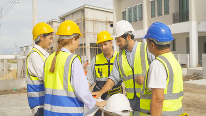 A group of workers, a designer team talk, communicate, discuss, and working on industrial construction site at home architecture building project. People lifestyle.