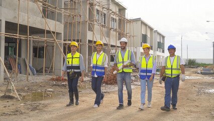 A group of workers, a designer team talk, communicate, discuss, and working on industrial construction site at home architecture building project. People lifestyle.