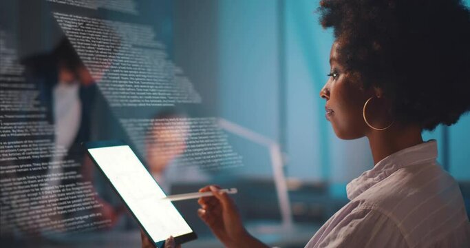 African-American businesswoman with tablet pc and virtual screen projection working in office