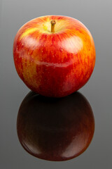 Braeburn apple on a black surface 