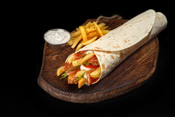 pork shawarma, doner kebab burrito stuffing for, french fries and pork with pita bread, dish on a...