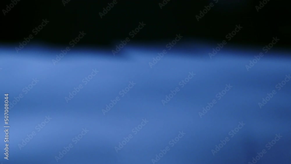 Poster real of water drop falls into water and diverging circles of water with smoot color background in st