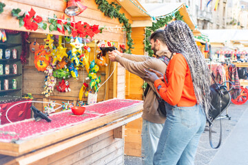 Young fun couple playing shooting games at amusement park - Young couple playing shooting games...