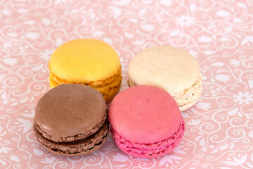 several macaroons on a pink background