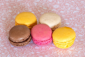 several macaroons on a pink background