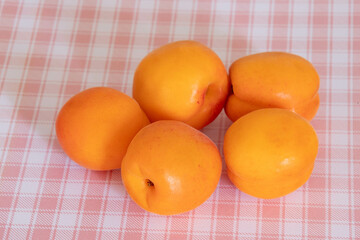 ripe apricots isolated on a pink background