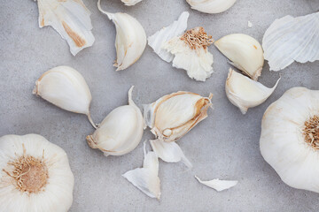 garlic bulb and cloves on rustic and mottled gray surface