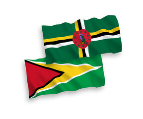 National vector fabric wave flags of Dominica and Co-operative Republic of Guyana isolated on white background. 1 to 2 proportion.