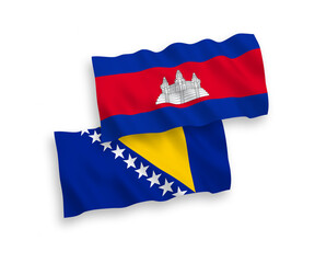 National vector fabric wave flags of Kingdom of Cambodia and Bosnia and Herzegovina isolated on white background. 1 to 2 proportion.