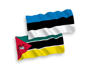 National vector fabric wave flags of Estonia and Republic of Mozambique isolated on white background. 1 to 2 proportion.