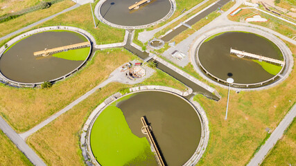 Aerial view of the tanks of a sewage and water treatment plant enabling the discharge and re-use of waste water. It's a sustainable water recycling with treatment plant.