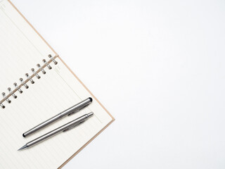 Silver pen on blank page diary top view copy space