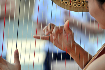 a chinese girl playing the harp