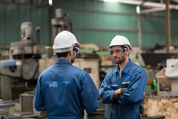 Portrait of engineer worker discussing about manufacturing machinery in the factory. Group of engineer male worker working in the manufacturing factory.