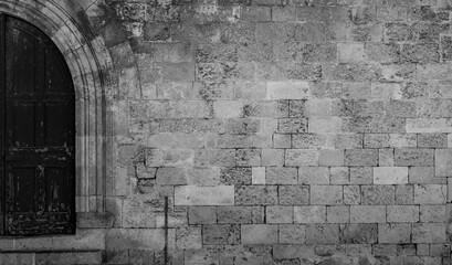 Antique  door and stone wall in black and white.
