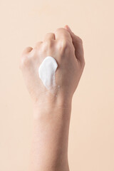 Cream moisturizer smear test on female hand, skin care product applied on woman hand