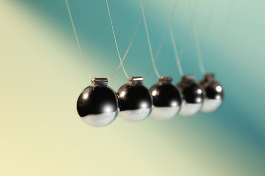 Newton's cradle on color background, closeup. Physics law of energy conservation