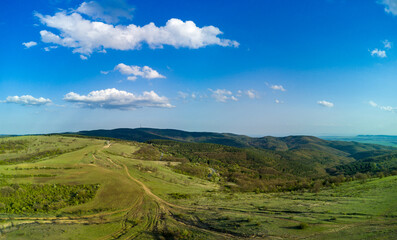Panorama of a view from a height of the meadows and slopes of the Balkan Mountains under daylight in Bulgaria