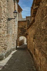 Fototapeta na wymiar medieval stone walkway with wall and archway