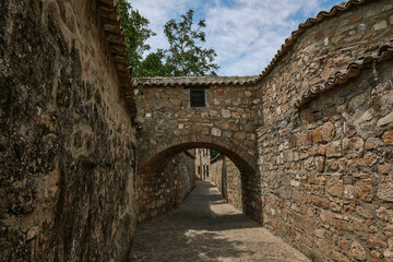 medieval stone walkway with wall and archway