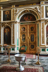 Orthodox Church. a baptismal font in front of the altar with icons decorated with gold and paintings