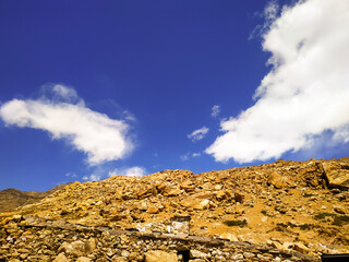 Clouds over the stones  mountains with blue sky