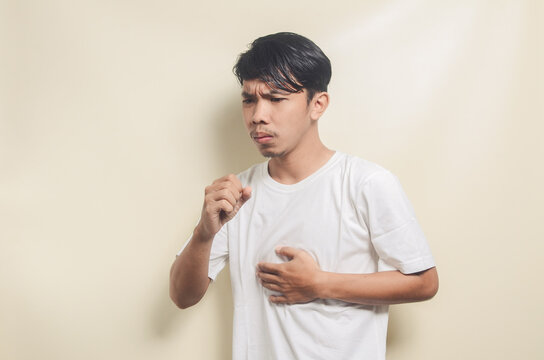 asian man wearing white t-shirt coughing on isolated background