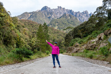 Woman in front of Mount Kinabalu view in Kundasang, Ranau, Sabah Borneo Malaysia