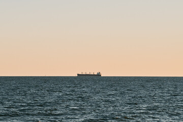 Distant ship over horizon. Commercial vessel in the Baltic Sea
